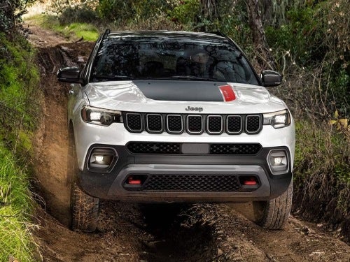 2024 Jeep Compass offroading through a muddy trail