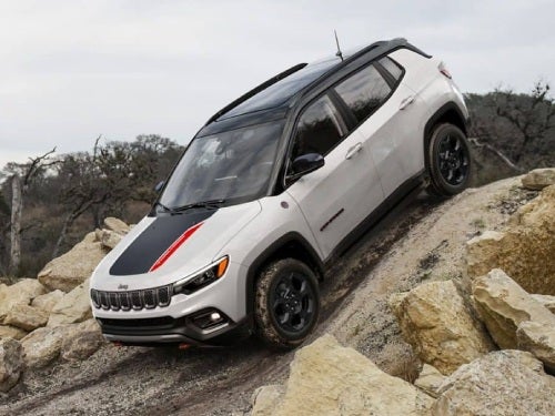 2024 Jeep Compass driving down a steep hill